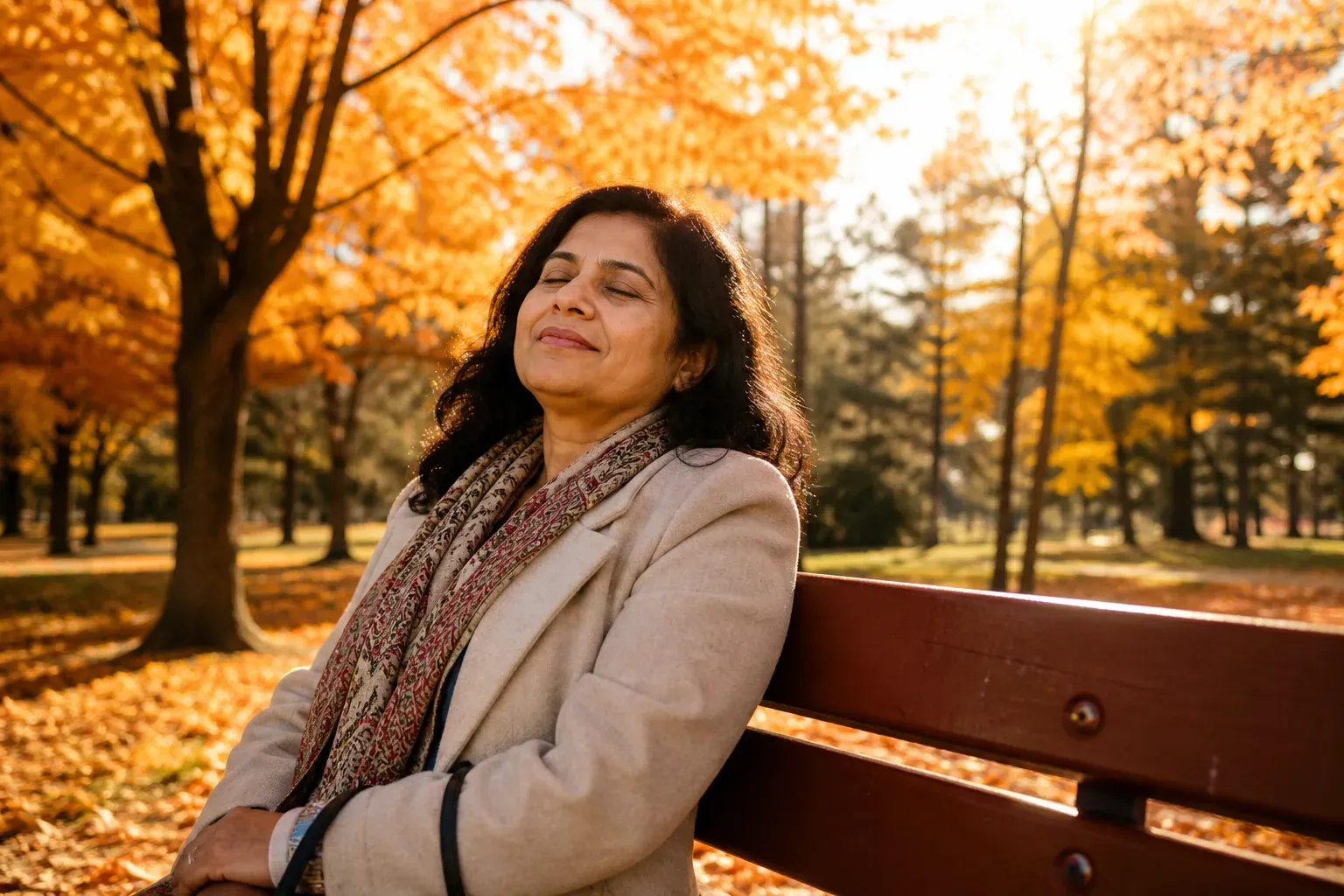 An older adult resting peacefully on a park bench on a golden autumn afternoon